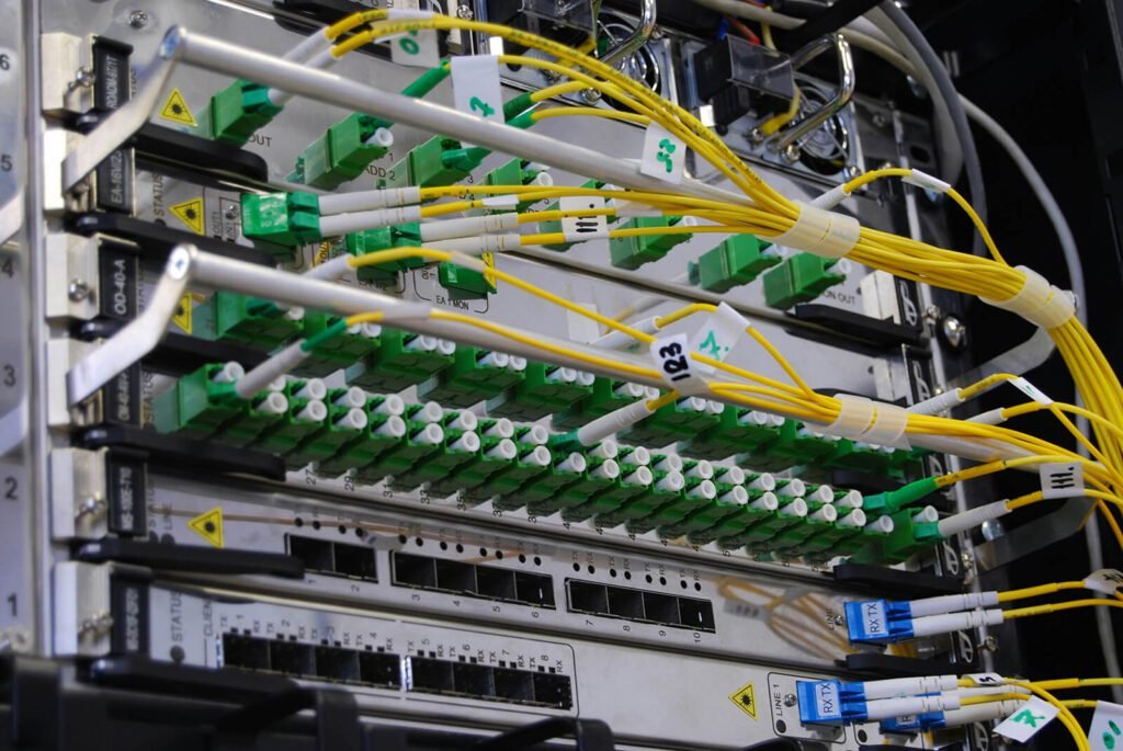 Optical fiber patch panel with SC connectors and organized cables.