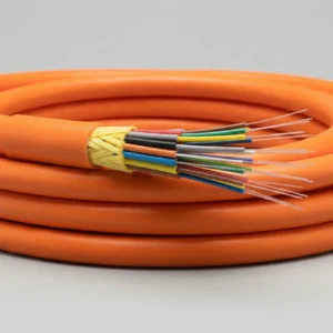 Close-up of GJFJV indoor distribution fiber optic cable with 900µm tight-buffered fibers, aramid yarn strength, and LSZH/PVC jacket.