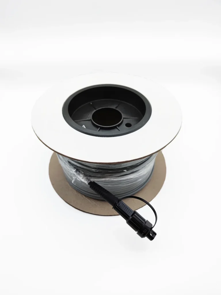 Top view of pre-connectorized Figure-8 drop cable on reel with SC/APC bullet end