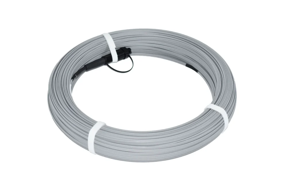 Grey pre-connectorized Figure-8 FTTH drop cable coil with hardened SC/APC (bullet) connector
