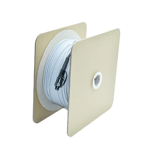 Pre-connectorized Figure-8 FTTH drop cable on cardboard reel, angled view with SC/APC bullet connector