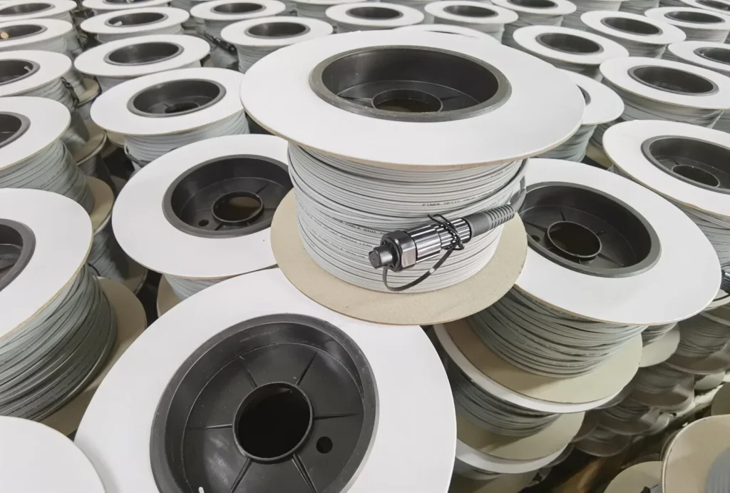 Warehouse stacks of pre-connectorized Figure-8 FTTH drop cable reels with SC/APC bullet connectors